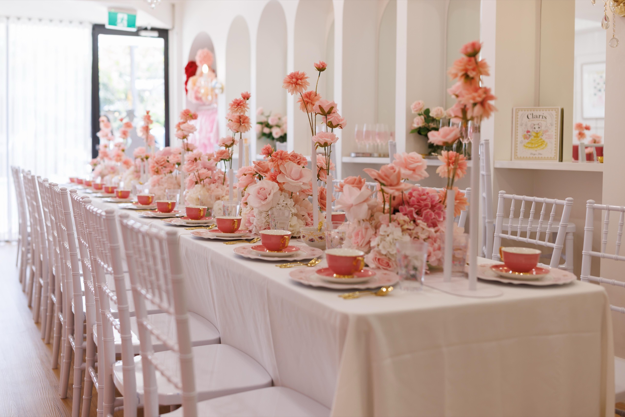 A long table styled with pink florals for a private event