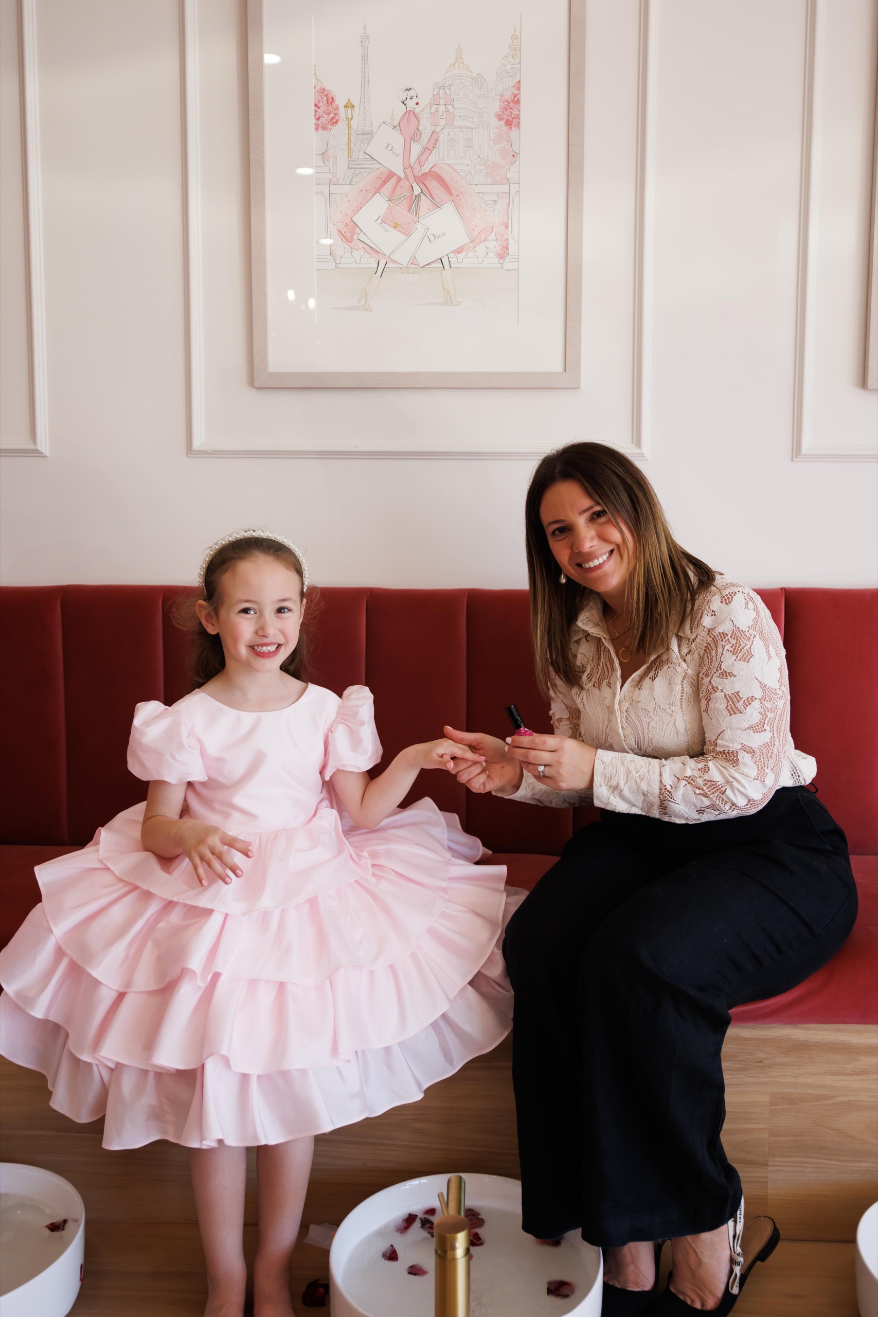A girl in a pink tulle dress with her mum